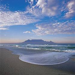 A View Of Table Mountain From Bloubergstrand With A Circle Of Foam And Waves In The Foreground And A Cloudy Sky Western Cape South Africa