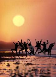 Group Jumping For Joy At Sunset