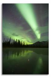 Curtains Of Green Aurora Borealis Dance Over A Frozen Pond , And Are Reflected On The Icy Surface The Boreal Forest And High Mountain Peaks Of The Central Brooks Range , Are Visible Behind