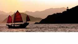 Traditional Chinese Junk And Green Island Lighthouse , Victoria Harbor , Hong Kong , China