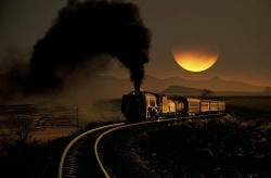 Steam Train Puffing Thick Black Smoke Winding Through Countryside , A Partially Obscured Sun Behind , Bethlehem , Free State , South Africa