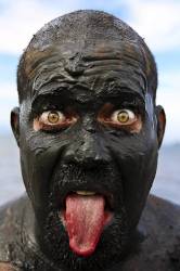 Bloco Da Lama In Paraty , Rio De Janeiro State , Brazil . Clad In Swimwear And Rags , Slathered In Mud , Adorned With Branches And Bones And Crying " Ooga Ooga Ha Ha " , Revelers Parade Through The Streets Of Paratys Colonial District Every Carnival Saturday Afternoon .