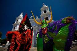 Masked Vejigantes In Front Of The The Cathedral Of Our Lady Of Guadalupe During Carnival In Ponce , Puerto Rico
