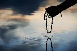 Japa Mala On Still Pond Landscape At Dawn