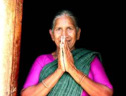 Indian Women In Doorway Greeting With Prayer Hands