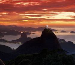Sunrise At Christ , The Redeemer Statue , Rio De Janeiro , Brazil . Sugar Loaf Mountain In The Background . Brazil Landmarks .