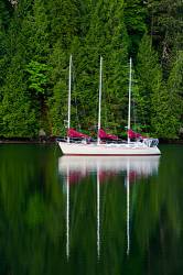 Three Masted Sailing Vessel At Anchor In A Sheltered Inlet , Vancouver Island , Canada