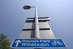 London Network Cycle Sign Giving Directions To Raynes Park And Wimbledon , In Motspur Park , Southwest London , England