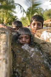 Indian Boys In Water Trough Portrait Shallow DOF
