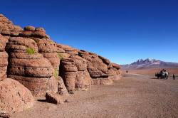 Yareta Plants ( Azorella Compacta ) Growing On Eroded Rock Outcrop , Toyota Land Cruiser In Background , Siloli Desert , Eduardo Avaroa Andean Fauna National Reserve , South Lipez Region , Bolivia