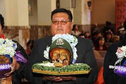 Devotee With Skull ( Ñatita ) Of A Deceased Policeman In Cemetery Church During Mass , Ñatitas Festival , La Paz , Bolivia