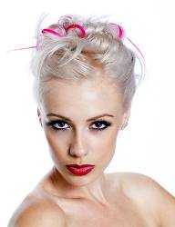 Portrait Of Pretty Young Woman With Blond And Pink Hair Against A White Background