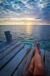 Legs On The Pier Watching The Sunrise , Ambergris Caye Belize , Central America