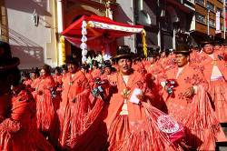 Cholitas Dancing The Morenada Parade Past The Figure Of El Señor Del Gran Poder , Gran Poder Festival , La Paz , Bolivia