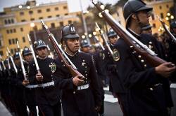 A Police Procession Marches Past The Presidential Palace In Lima , Peru .