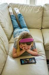 Nine-year-old Girl Watching A Film On Her Tablet Computer