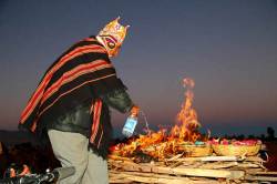 Aymara Shaman Or Amauta Pouring Alcohol On Burning Offerings During Rituals For Aymara New Year / June 21st Winter Solstice Celebrations , Tiwanaku , Bolivia