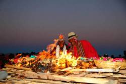 Aymara Men Watch Offerings Burning During Rituals For Aymara New Year / June 21st Winter Solstice Celebrations , Tiwanaku , Bolivia