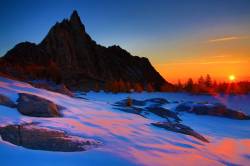 Sunrise Prusik Peak Over A Frozen Gnome Tarn In The Enchantments In The Apline Lakes Wilderness Of Washington