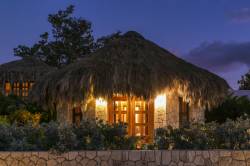 Boutique Hotel Cottages With Thatched Roof At Night, Negril, Jamaica