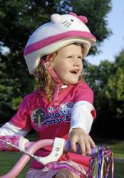 Smiling Five Year Old Girl With Bike Safety Helmet.