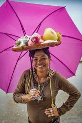 A Filipino Woman Carries A Bamboo Basket Full Of Fruit On Her Head In Baloy Long Beach , Subic Bay , Luzon Island , Philippines , Southeast Asia .