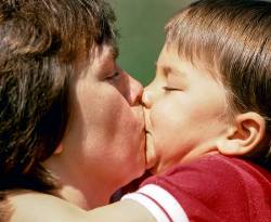 A Three-year Old Boy Plants A Huge Kiss On His Mother In Plainfield , New Hampshire , United States .