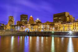 The Old Port Section Of French Montreal Viewed In The Evening Across The Bassin River At Montreal City , Quebec Province , Canada , North America .