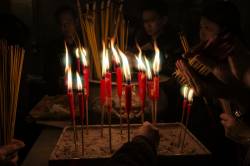 Lighting Incense Sticks At The Famous Man Mo Temple, Hong Kong , China.
