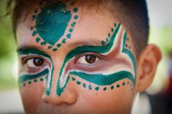 Close-up Portrait Of A Teenage Filipino High School Boy With Green And White Face Paint Designs Specific To His Tribal Heritage. He Is Part Of The Multi-cultural Festival Celebration Held In Puerto Princesa Every Year On Palawan Island, Philippines.