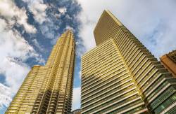 Petronas Tower #2 And Adjacent Buildings Glow Golden During Sunset In Kuala Lumpur, Malaysia, Southease Asia.