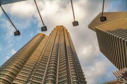 Tower #2 Of The Petronas Twin Towers Glows Bronze Gold Color In Late Afternoon Sunset At Kuala Lumpur, Malaysia, Southeast Asia.