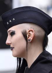 Side Profile Of A Young Woman With Ear And Lip Studs, Black Eye Make-up And Wearing A Military Cap At The Leipzig Goth Festival (Wave-Gotik-Treffen) Leipzig, Germany, May 2016