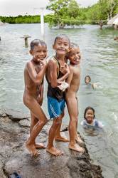 Three Young Filipino Boys Pause During Their Swimming Play To Ham It Up For The Camera At Tinangnan, Bohol Island, Philippines.