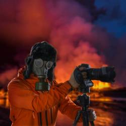 Photographer Wearing A Gas Mask In Front Of Glowing Lava.Holuhraun, Bardarbunga Volcano Eruption, Iceland