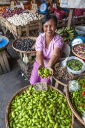 A Filipino Woman Vendor Offers Kamias Fruit, Averrhoa Bilimbi, For Sale At Her Stall In The Local Open Market In Legaspi, Luzon Island, Philippines.