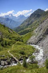 Woman Trekking And Crossing The Ferrand River In The Valley Ferrand, Oisans, France, Europe.