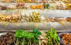 Street Food Stall Is Filled With Skewered Vegetables, Meat And Fish Ready For Cooking. Most Skewers Are Color Coded For Pricing. Location Is Bukit Bintang, Kuala Lumpur, Malaysia.