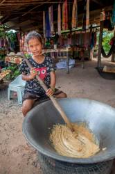 A Ten-year Old Khmer Girl Helps Her Mother Make Palm Sugar Candy For Selling To Tourists On The Road To Banteay Srei, Kingdom Of Cambodia.