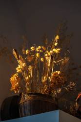 A Woven Basket Of Dried Grasses Decorates A Shelf.