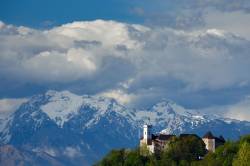 View Across The City To Ljubljana Castle With The Snowcapped Kamnik Alps Forming A Picture Perfect Background.