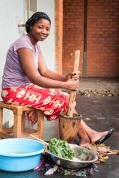 Portrait Of A Young Zambian Woman With Pestle And Mortar