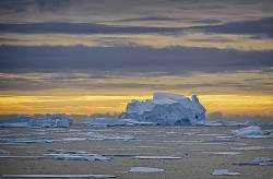 Large Iceberg And Floating Sea Ice At Sunset, Antarctica