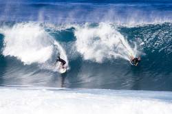 Surfer And Bodyboarder Riding The Same Wave In Banzai Pipeline, Oahu, Hawaii, USA