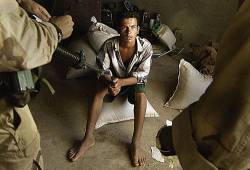 A Teenage Boy Listens Attentively As U S Soldiers Question Him August 20 , 2004 About The Insurgent Activity Happening Near Logistics Support Area Anaconda / Balad Air Base , Iraq