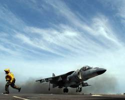 Atlantic Ocean ( April 23 , 2005 ) Aviation Boatswains Mate 2nd Class Courtney F Godfrey Runs Behind The Foul Line As A Marine Corps Av 8b Harrier Ii+ , Assigned To The òbulldogsó Of Marine Attack Squadron Two Two Three ( Vma 223 ) , Performs A Vertical Takeoff From The Flight Deck Of The Amphibious Assault Ship Uss Iwo Jima ( Lhd 7 ) The Av 8b Is A High Performance , Single Engine , Single Seat , Vertical / Short Take Off And Landing ( V / Stol ) Attack Aircraft The Av 8b Harrier Ii+ Is Capable Of Night And Adverse Weather Operations Due To The Addition Of The An / Apg 65 Multi Mode Radar The Fusion Of Night And Radar Capabilities Allows The Harrier To Be Responsive To The Marine Air Ground Task Forces Needs For Expeditionary , Night And Adverse Weather , Offensive Air Support Iwo Jima Is Currently Conducting Training Operations In The Atlantic Ocean Us Navy Photo By Photographers Mate 1st Class Robet J Fluegel ( Released )