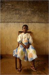 A Young Ghanaian Girl Wears Her Finest Clothes As She Waits To See American Doctors From Navy Fleet Hospital Minneapolis Sailors Participating In A Medical Outreach Program , As Part Of The West African Training Cruise , Set Up Clinics In Eight Western Ghanaian Villages