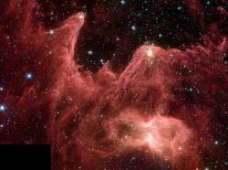 This Fantastic Skyscape Lies At The Eastern Edge Of Giant Stellar Nursery W5 , About 7 , 000 Light Years Away In The Constellation Cassiopeia An Infrared View From The Spitzer Space Telescope , It Features Interstellar Clouds Of Cold Gas And Dust Sculpted By Winds And Radiation From A Hot , Massive Star Outside The Picture ( Just Above And To The Right ) Still Swaddled Within The Cosmic Clouds , Newborn Stars Are Revealed By Spitzers Penetrating Gaze , Their Formation Also Triggered By The Massive Star Fittingly Dubbed " Mountains Of Creation " , These Interstellar Clouds Are About 10 Times The Size Of The Analogous Pillars Of Creation In M16 , Made Famous In A 1995 Hubble Space Telescope View W5 Is Also Known As IC 1848 And Together With IC 1805 It Is Part Of A Complex Region Popularly Dubbed The Heart And Soul Nebulae The Spitzer Image Spans About 70 Light Years At The Distance Of W5