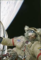 Cosmonaut Salizhan S Sharipov , Expedition 10 Flight Engineer Representing Russias Federal Space Agency , Wearing A Russian Orlan Spacesuit , Participates In The First Of Two Sessions Of Extravehicular Activities ( EVA ) Performed By The Expedition 10 Crew During Their Six Month Mission Sharipov And Astronaut Leroy Chiao ( Out Of Frame ) , Mission Commander And NASA ISS Science Officer , Spent 5 ½ Hours Outside The International Space Station ( ISS ) Installing A Work Platform , Cables And Robotic And Scientific Experiments On The Exterior Of The Zvezda Service Module Earths Horizon And The Blackness Of Space Provided The Backdrop For The Image ( 26 January 2025 )