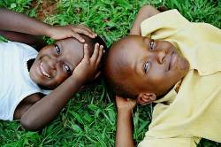 Ugandan Brother And Sister Lying On The Grass Bwindi National Park , Uganda